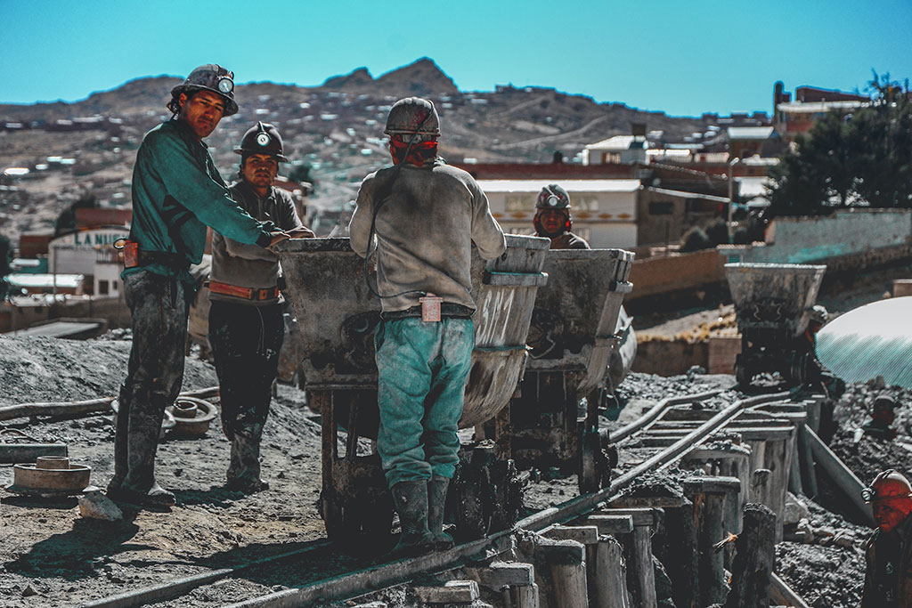 Group of coal miners working above ground